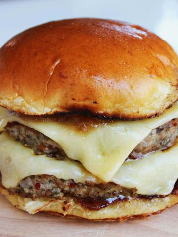 Pork burger with cheddar cheese and a rhubarb and apple chutney