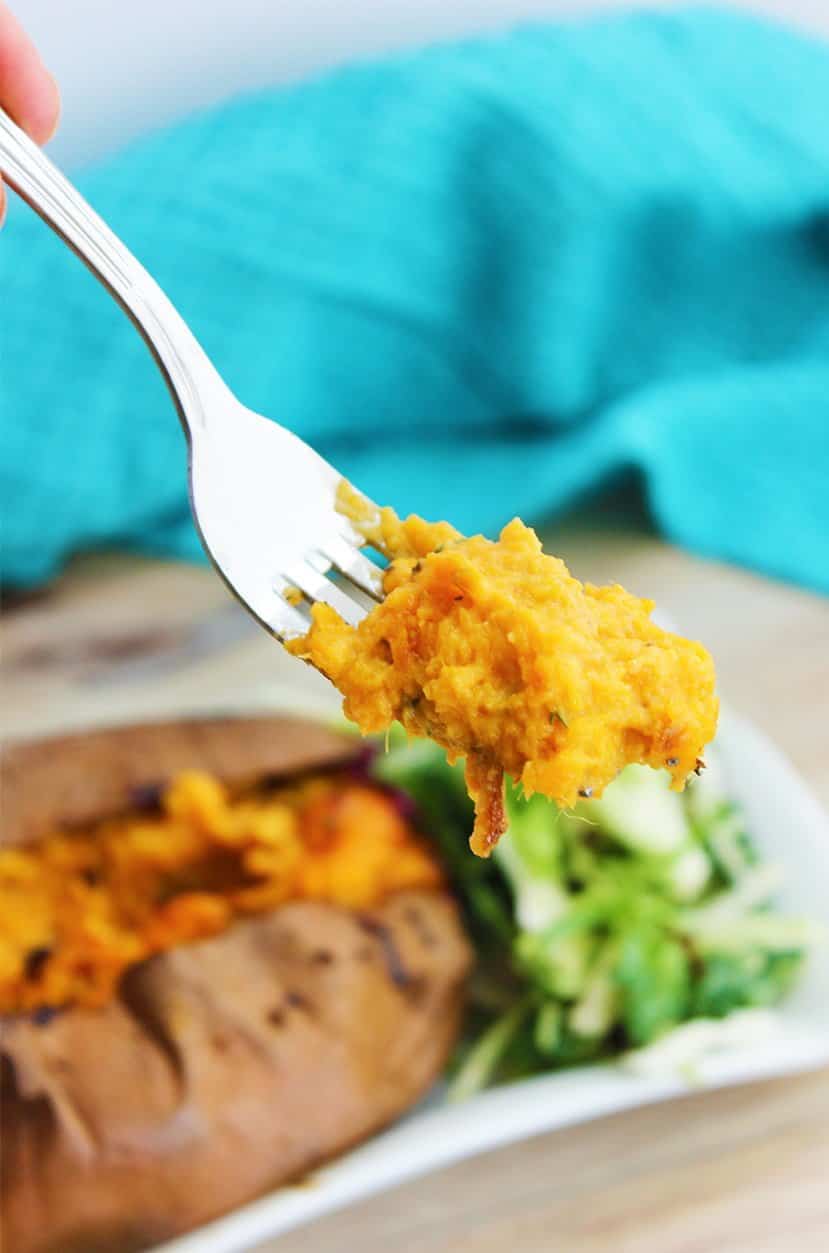 The filling of a twice baked sweet potato on a fork