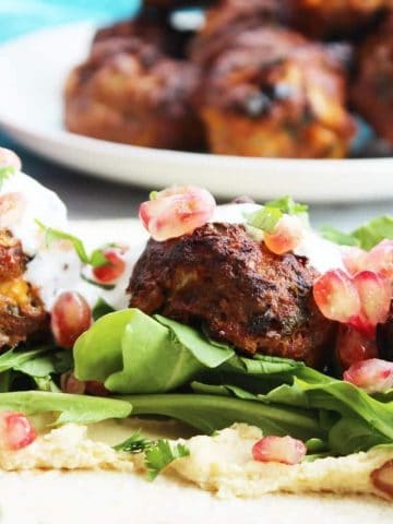 Lamb meatballs dressed on a bed of salad