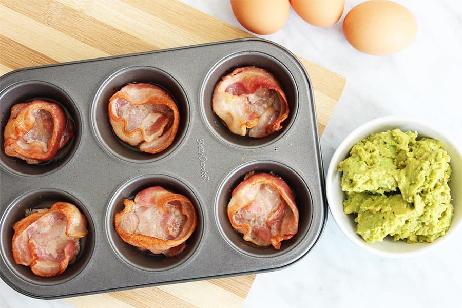 top down shot of cooked bacon in a muffin tin