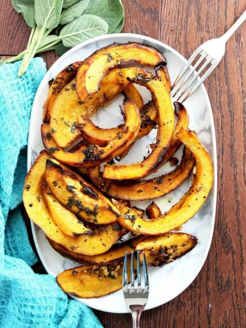 Top down shot of baked pumpkin on a serving dish with two forks
