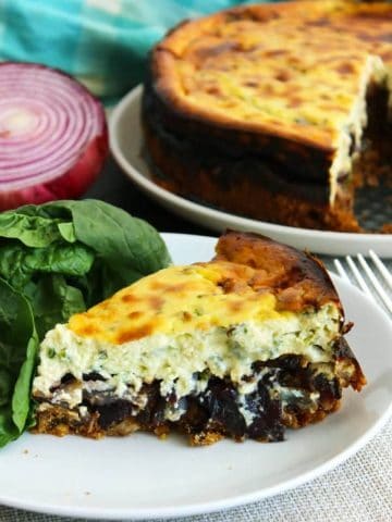 A slice of savoury cheesecake served with a side salad