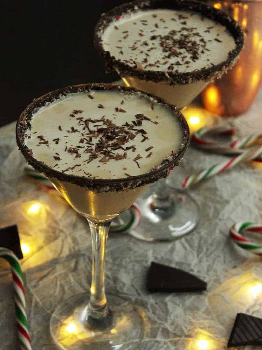 Two glasses of Christmas Candy Cane cocktail with chocolate shavings