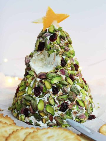 A Christmas Tree Cheese Ball with a section scooped out
