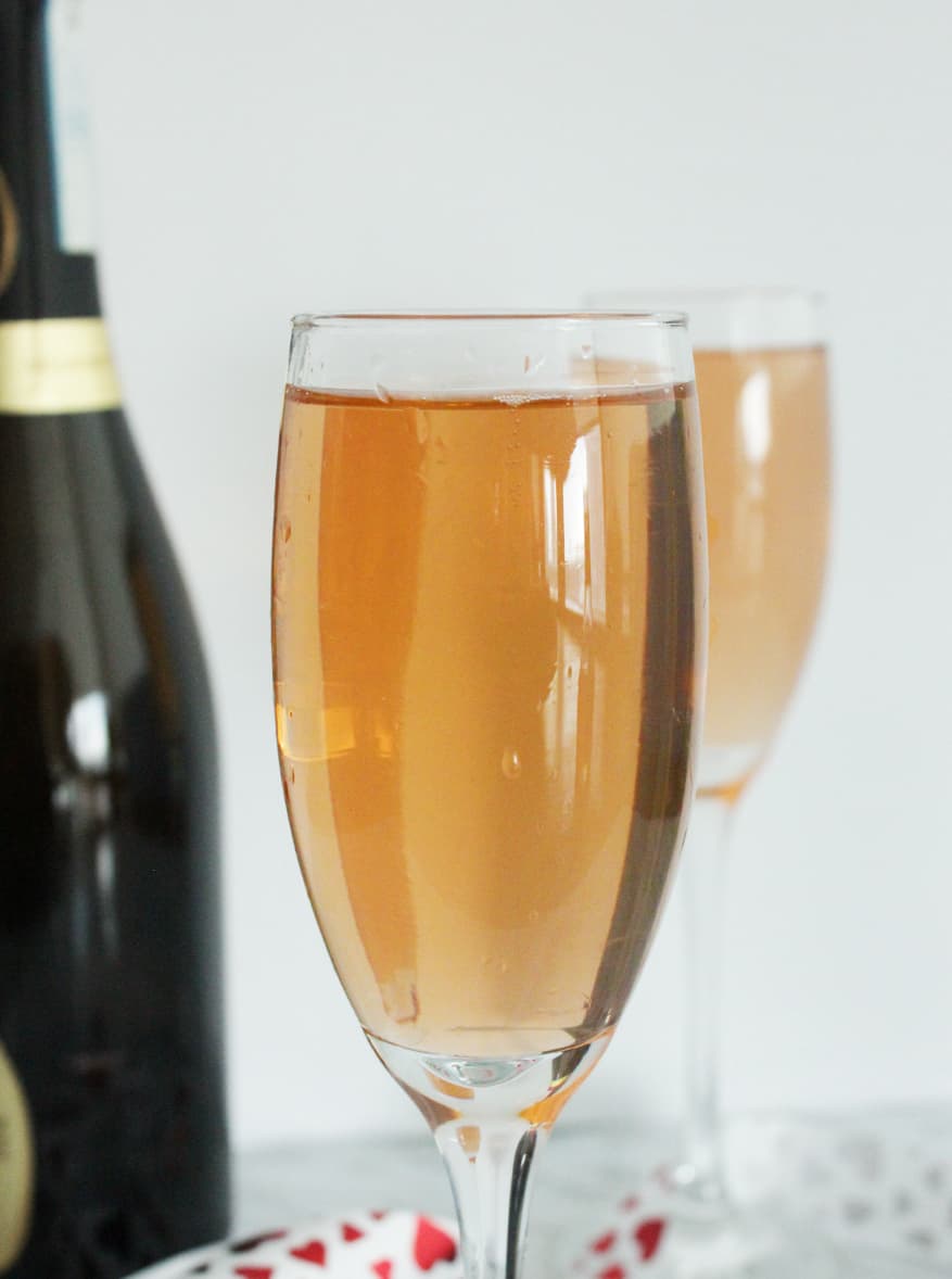 Close up of a prosecco cocktail on a white background