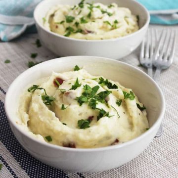 Two bowls of blue cheese mashed potato on a placemat