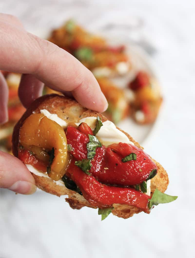 A crostini appetizer held towards camera