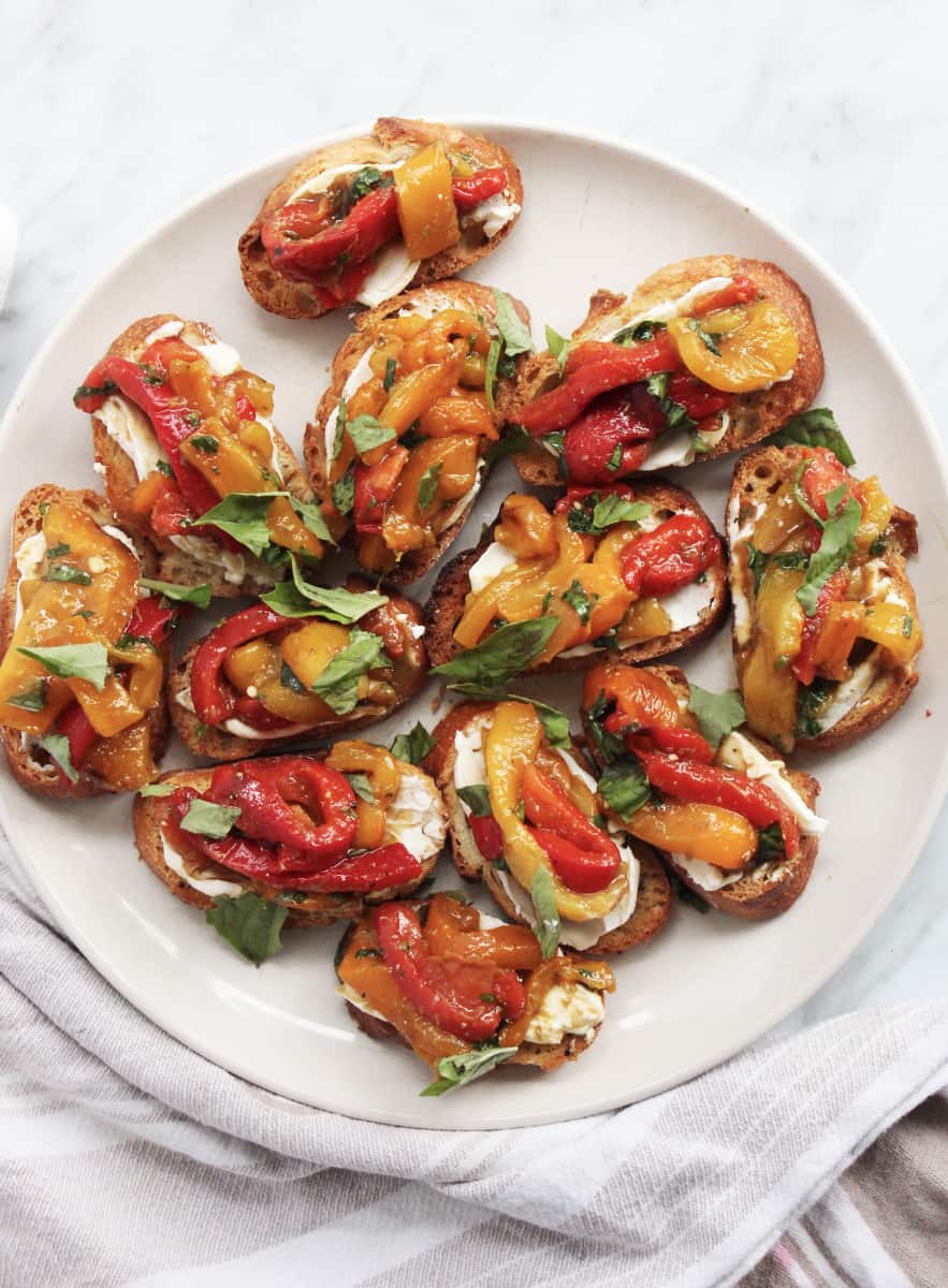 Crostini appetizers arranged on a white plate