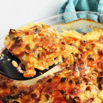 A slice of sweet potato dauphinoise being held towards camera