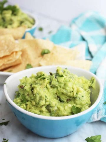 Close up of jalapeno guacamole in a blue bowl