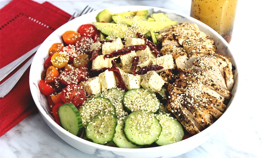 A large bowl of Grilled Lemon and Herb Chicken Salad