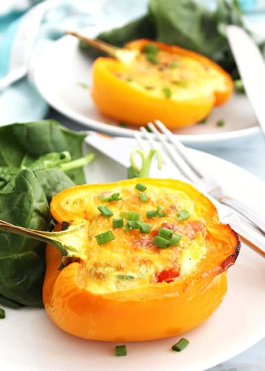 Breakfast stuffed peppers served on a white plate
