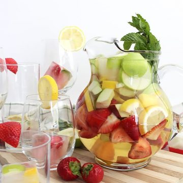 A jug of white wine sangria with fresh fruit