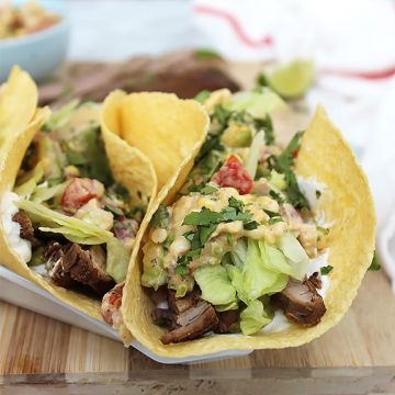 A flank steak taco with toppings folded