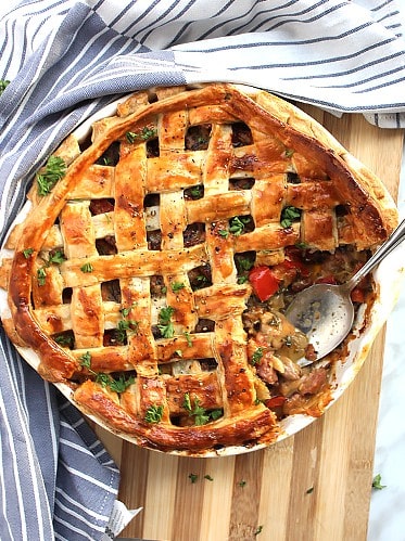 The baked pie on a wooden chopping board