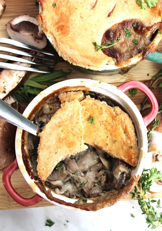 A mushroom pot pie with the crust broken so that you can see the filling
