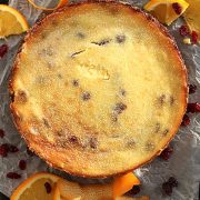 A baked cranberry and orange cheesecake on parchment paper