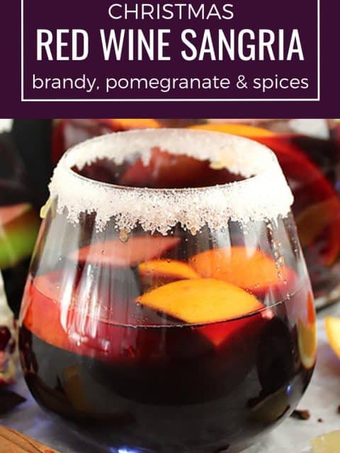 Pinterest image. A glass of Christmas red wine sangria with text overlay