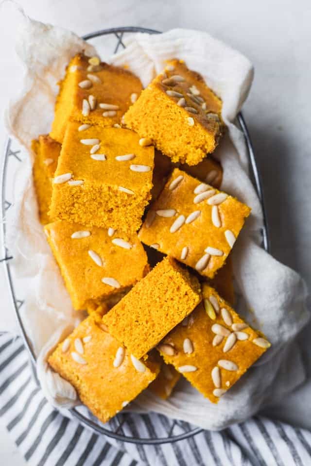 Squares of turmeric cake on a white plate