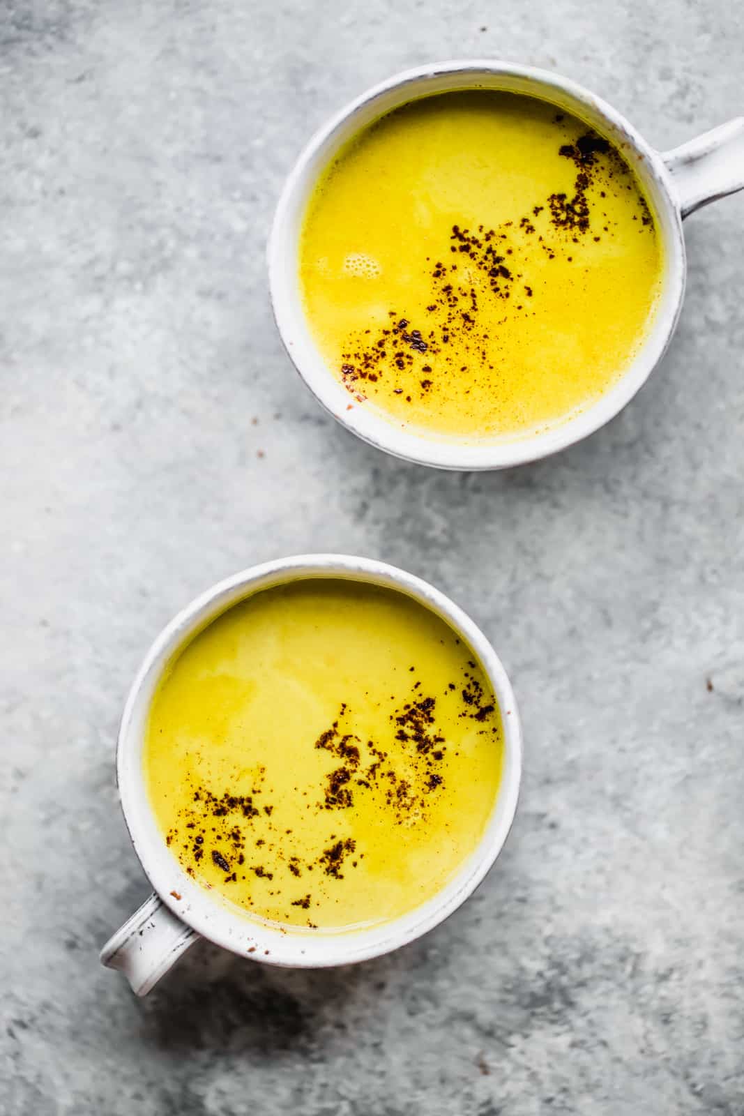 Turmeric lattes served in two white cups