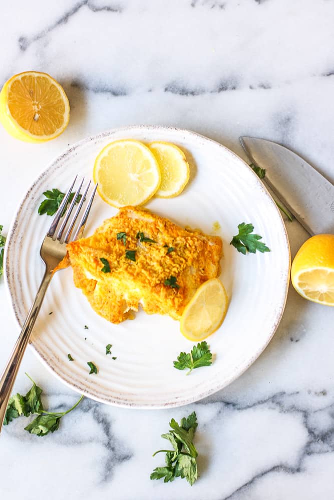 turmeric cod served on a white plate