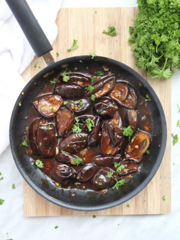 Stir fried baby eggplant in a frying pan