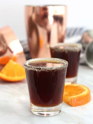 A chocolate orange shot next to an orange slice