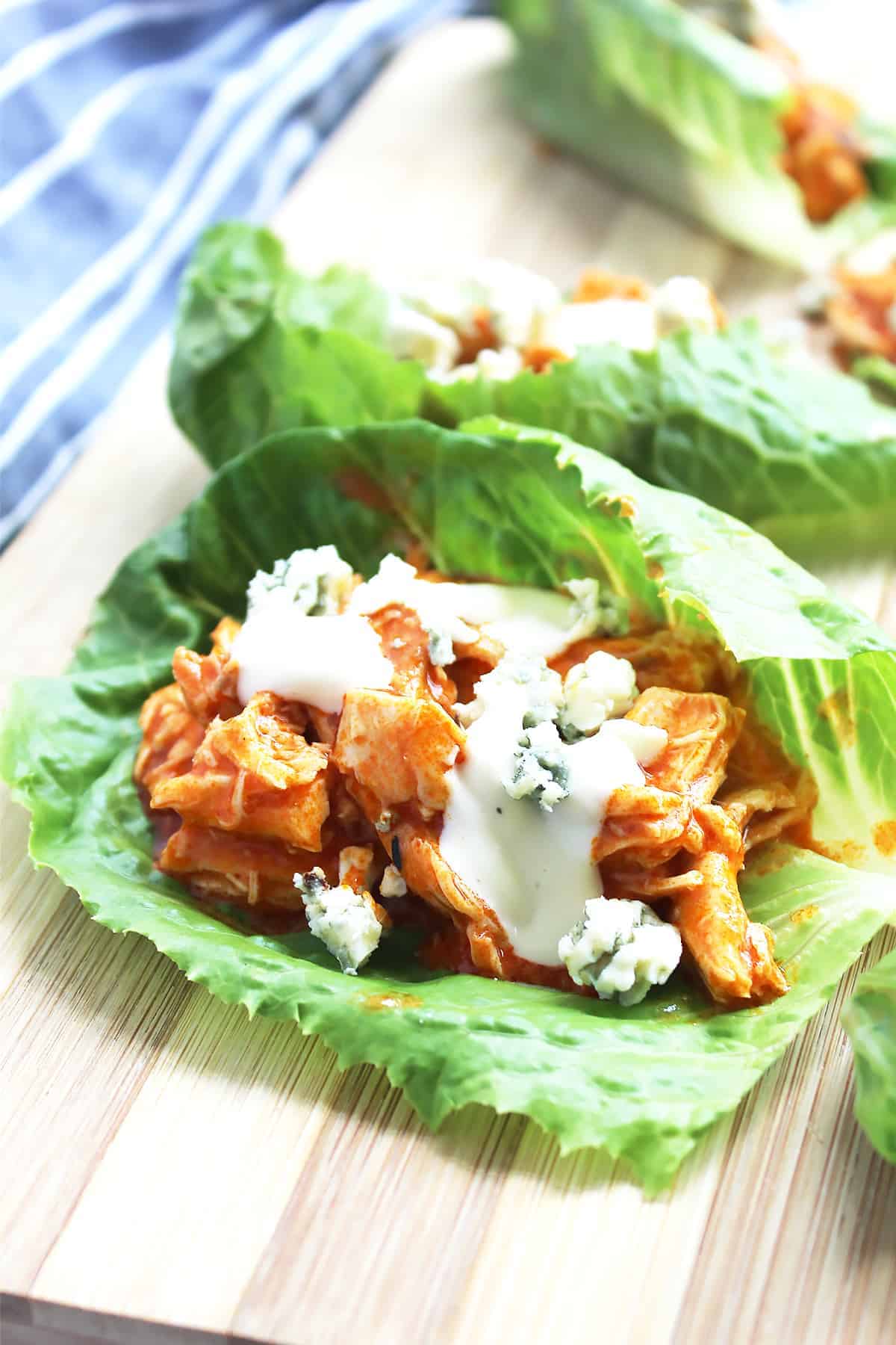 Lettuce wraps topped with chicken, blue cheese and ranch dressing