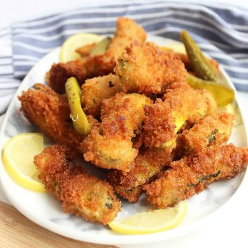 Fried pickles stacked on top of each other on a plate