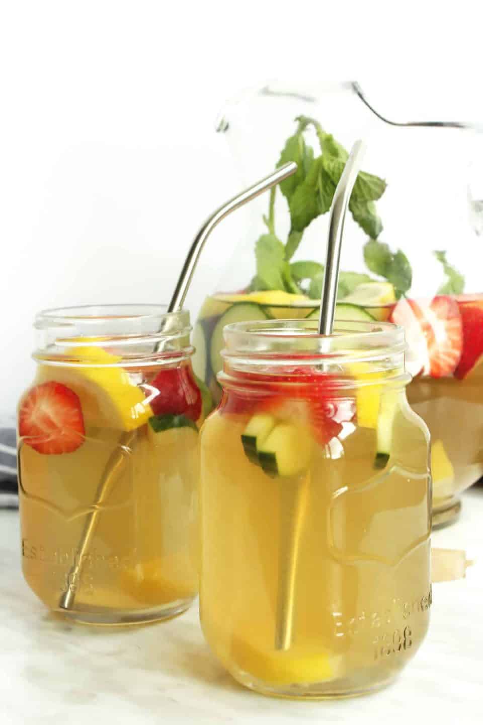 Two mason jar glasses with iced green tea