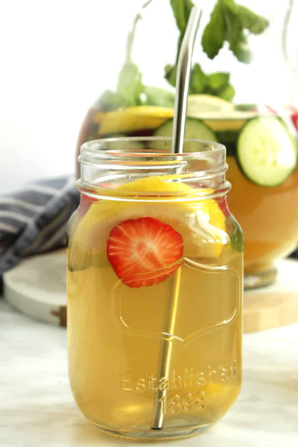 A glass of iced green tea with fresh fruit