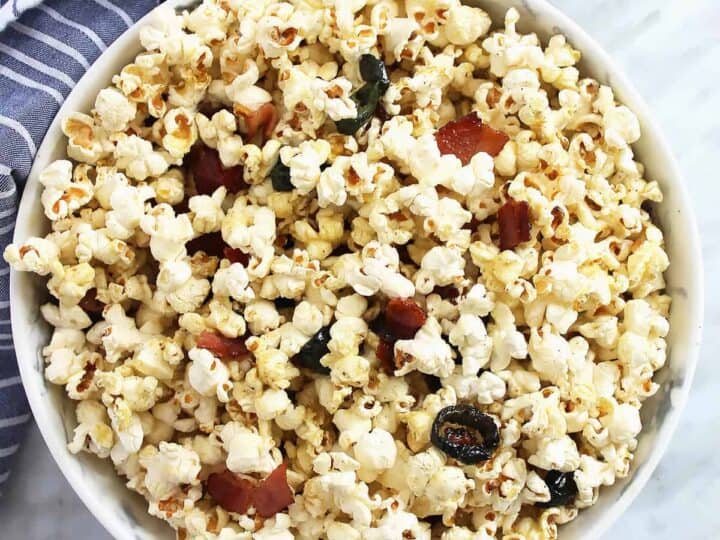 Overhead shot of a bowl of popcorn with a blue cloth underneath
