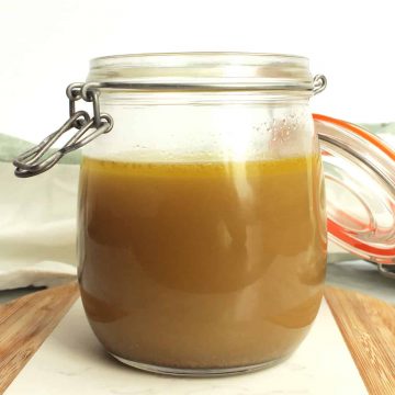 Side view of chicken stock in a glass mason jar