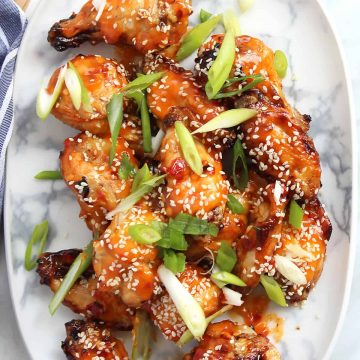 PIneapple and chili chicken wings on a marble white plate