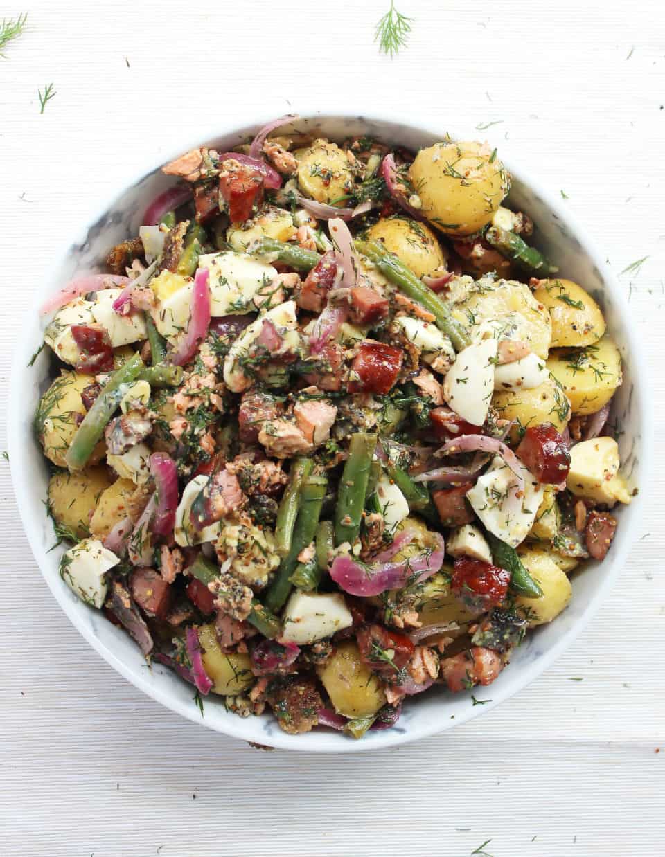 The potato salad garnished with fresh dill