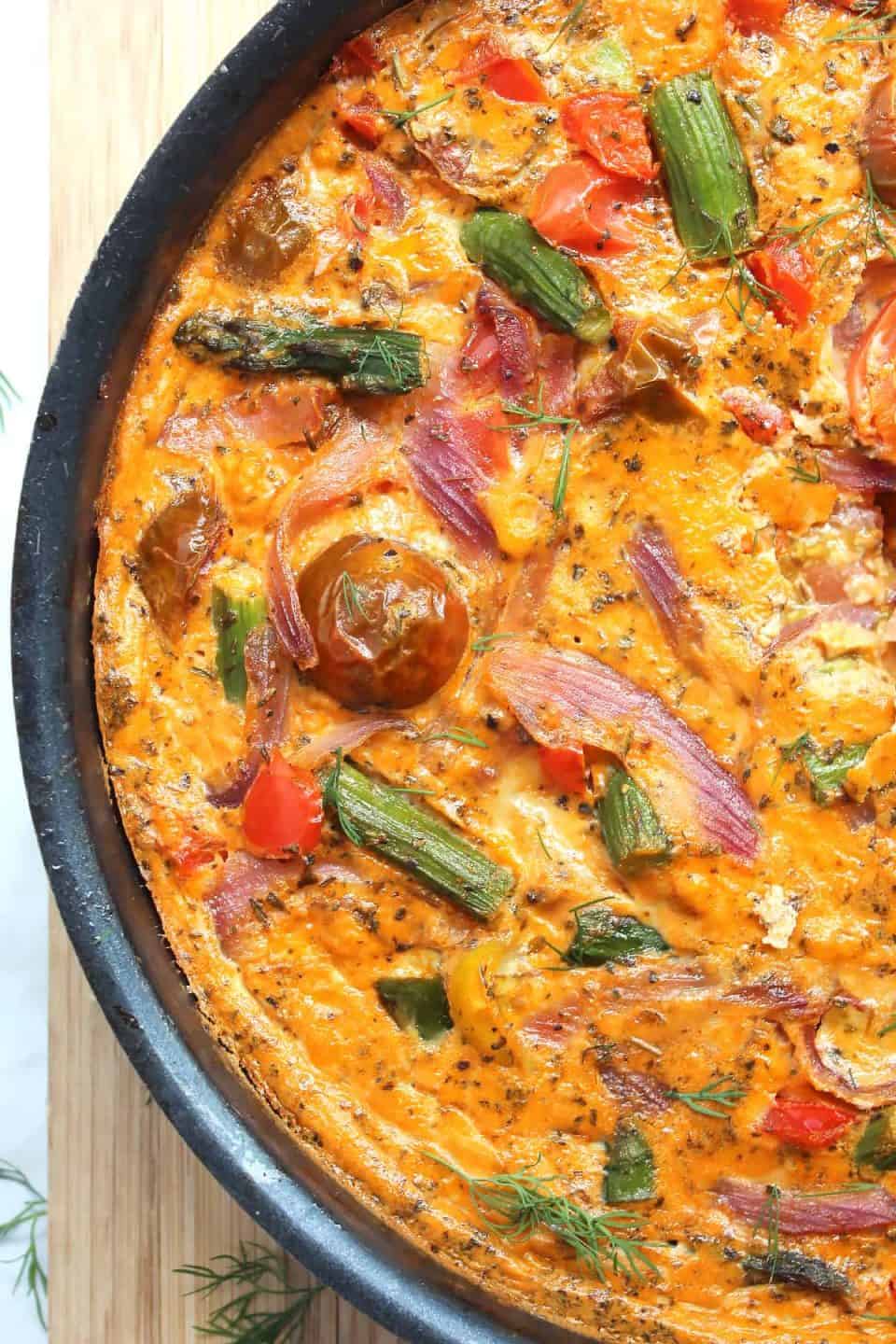 A baked red pesto frittata in a frying pan