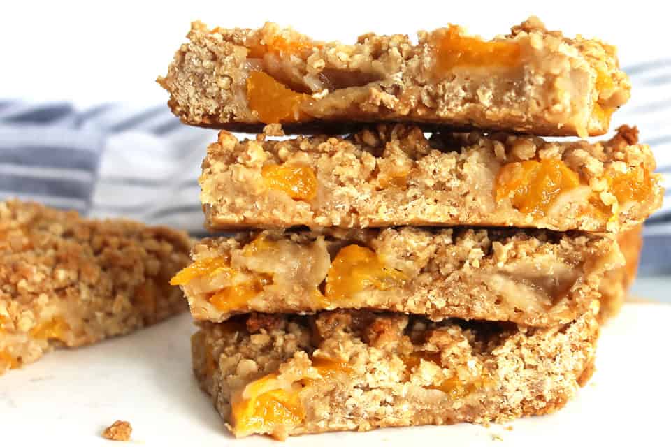Peach oatmeal bars stacked on top of each other