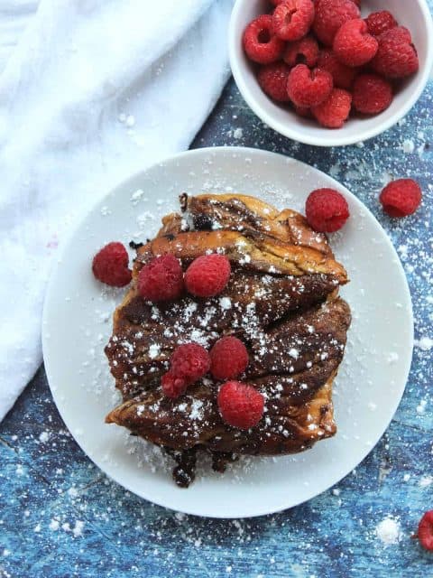 Overhead shot of chocolate stuffed French toast served with raspberries.