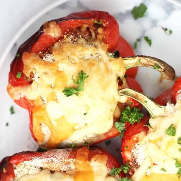 Close up of a chicken parmesan stuffed pepper topped with melted cheese.