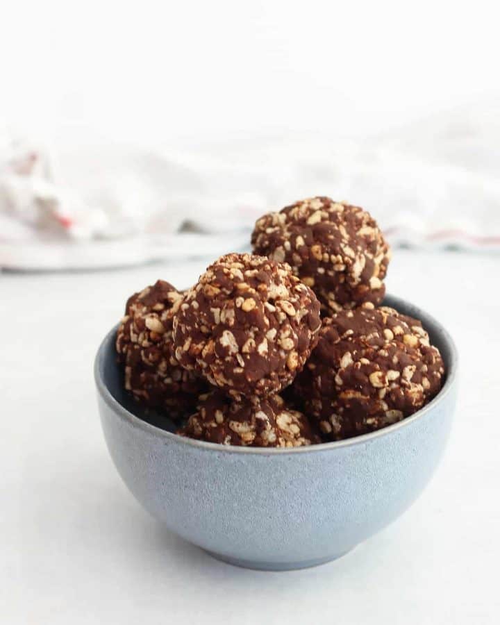A blue bowl with chocolate balls.