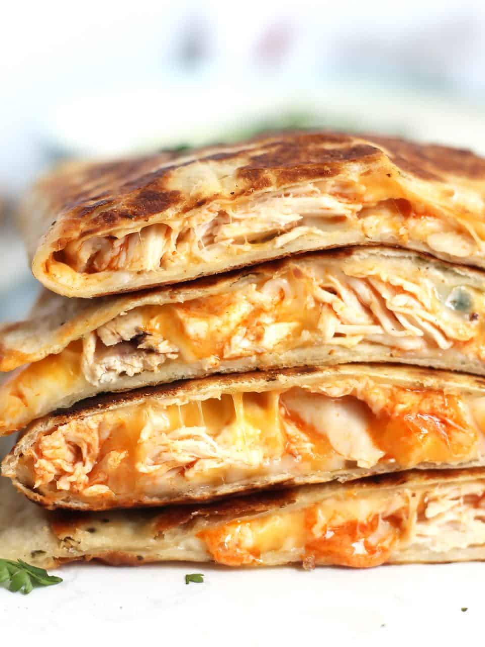 Buffalo chicken quesadillas cut in half and stacked on top of each other.