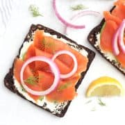 Smoked salmon on rye bread with red onions.