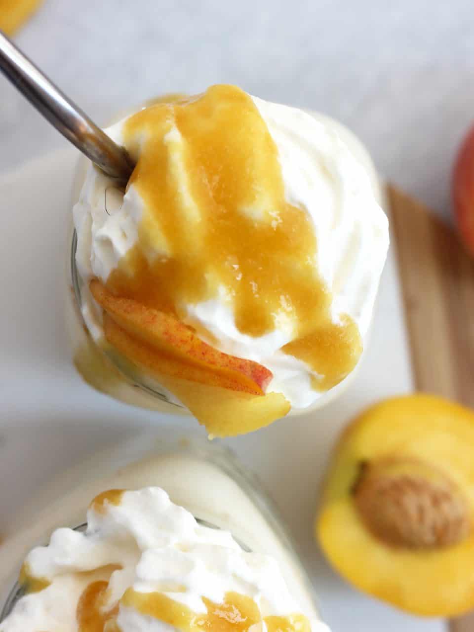 Overhead shot of the whipped cream, fresh peach and peach puree toppings.