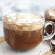 A coconut mocha with whipped cream in a glass cup.