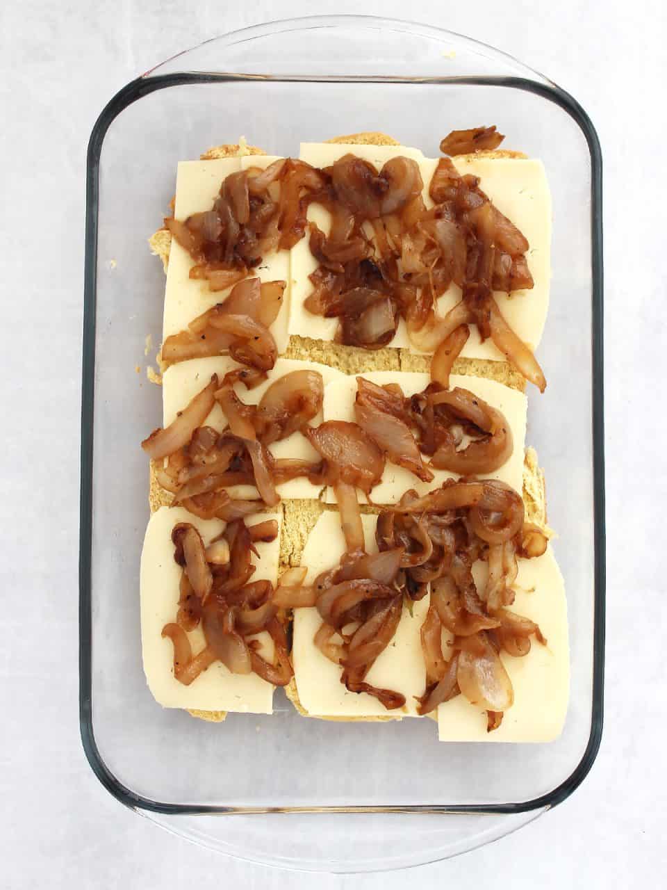 Caramelized onions placed on top of the cheese slices.
