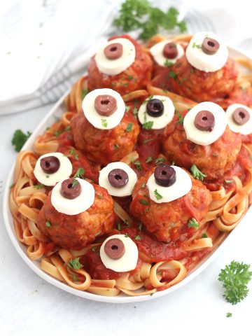 Halloween spaghetti and meatballs served on a large platter.