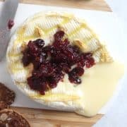 Cranberry sauce on top of a wheel of air fryer camembert.