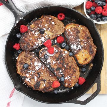 Four slices of pumpkin spice french toast in a skillet.