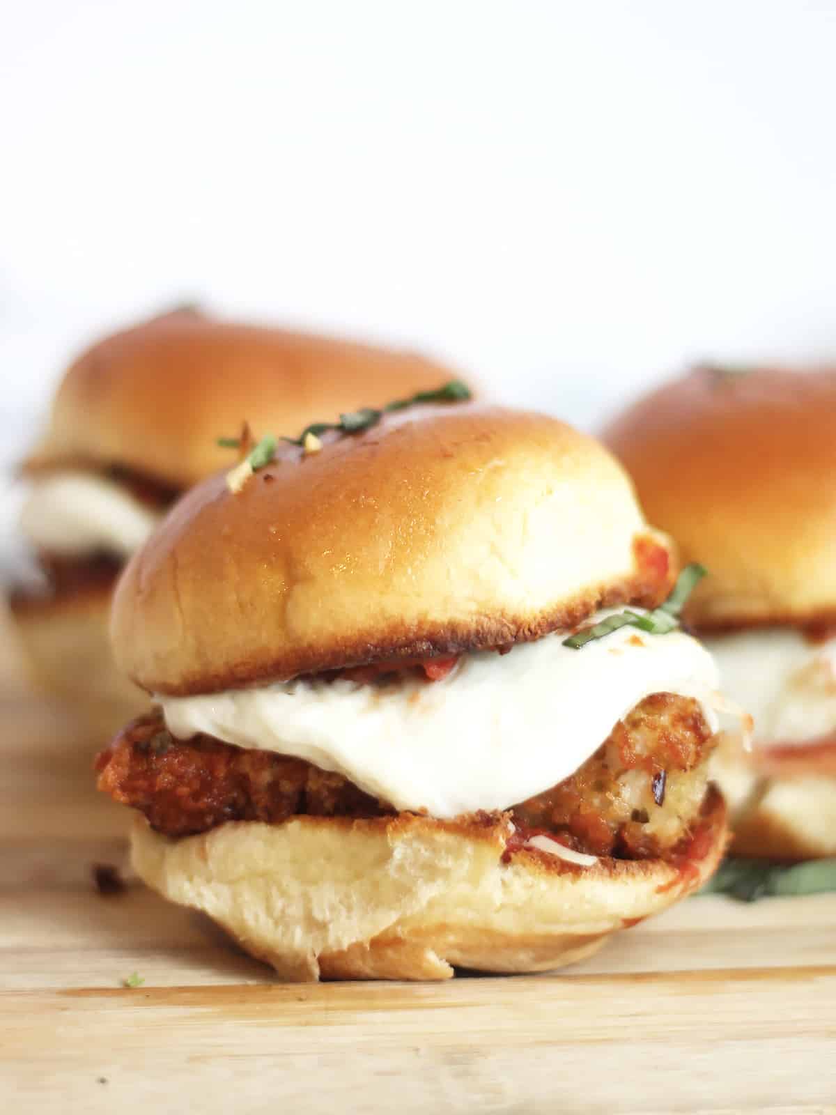 A slider with crispy chicken and melted mozzarella.