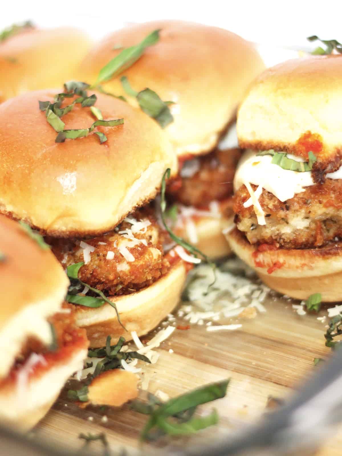 Chicken sliders in a glass baking dish.